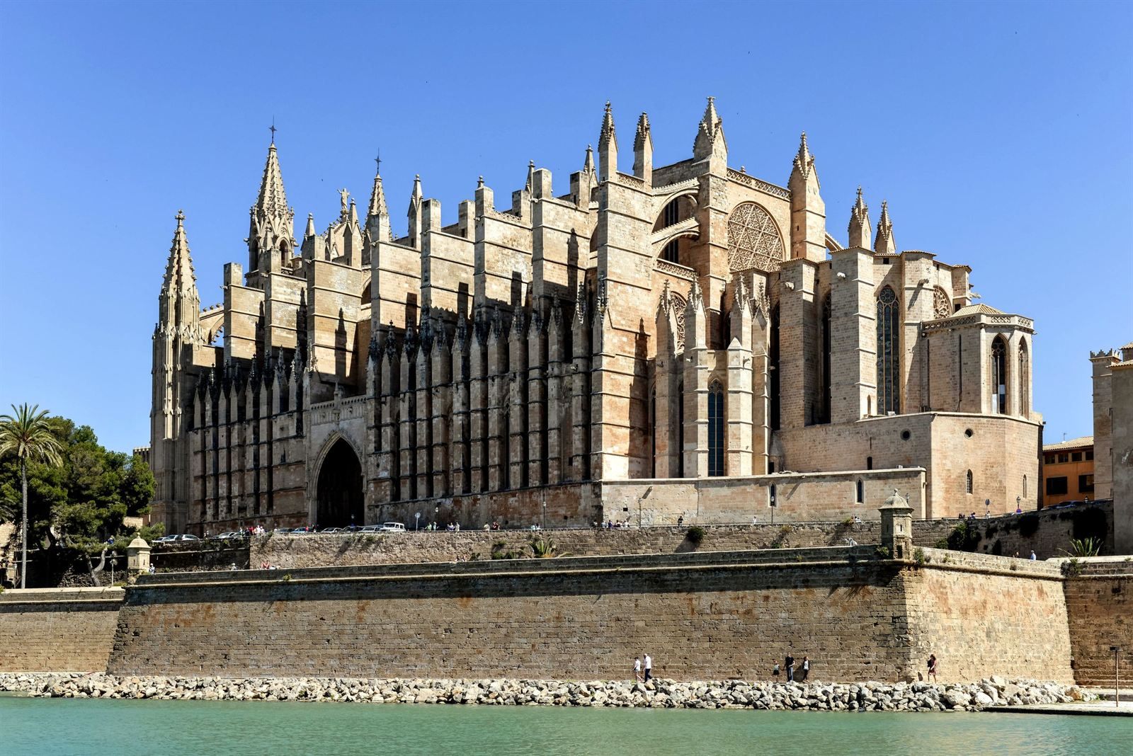 Gothic cathedral of Palma de Mallorca rising above the old stone sea walls