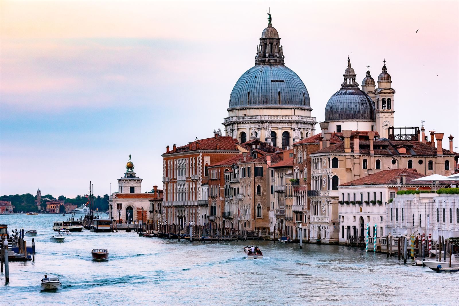Domes of Santa Maria della Salute above the Grand Canal in Venice, with water taxis passing
